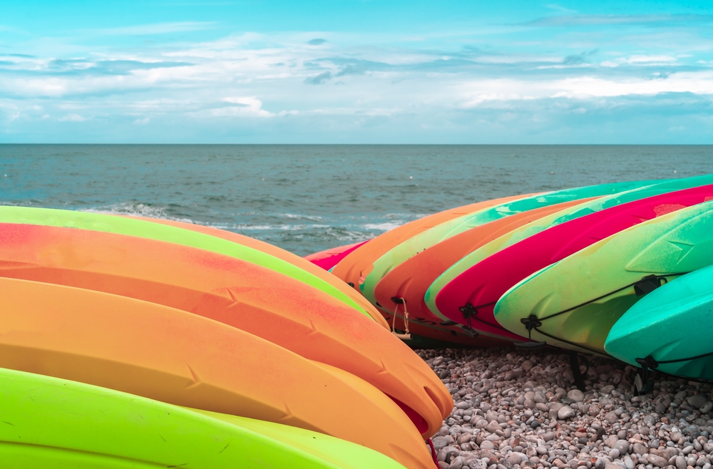 Kayaks,Of,Different,Colors,Stacked,On,The,Shores,Of,Atlantic