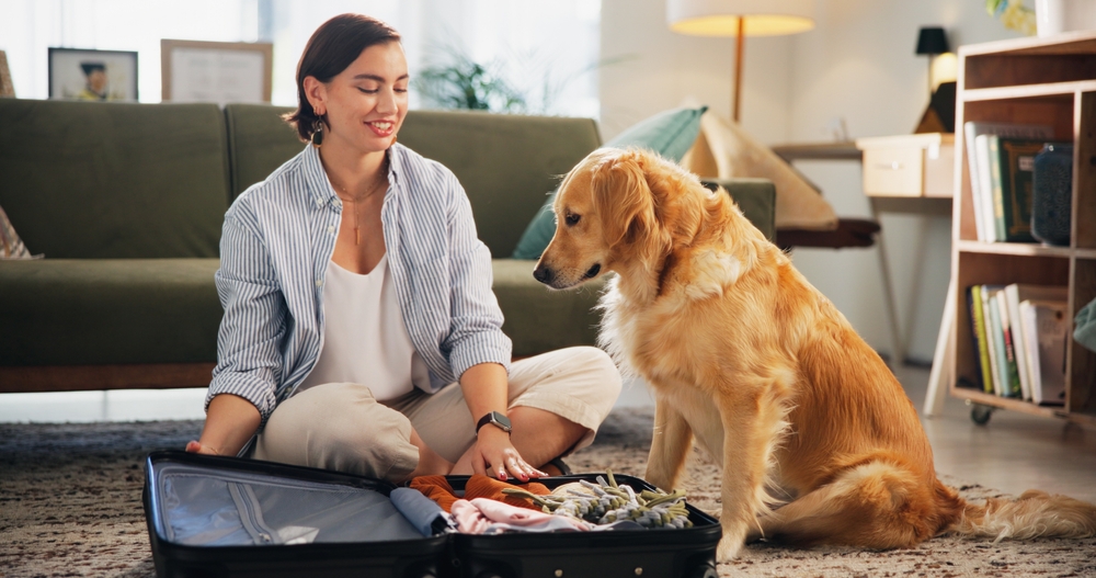 Suitcase,,Clothes,And,Woman,With,Dog,In,Home,Packing,For